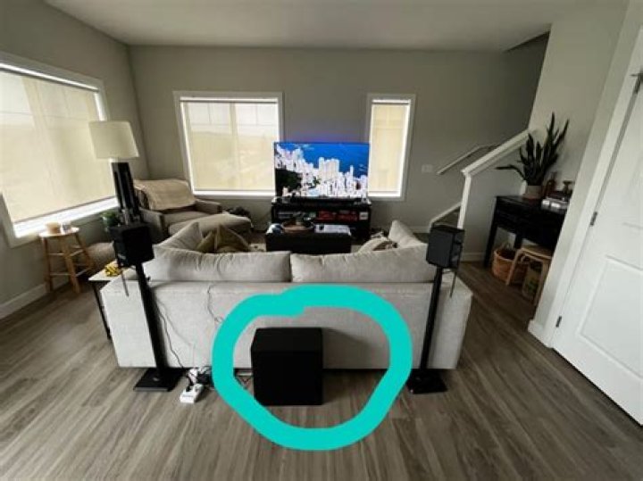 Can a subwoofer be placed behind a couch?