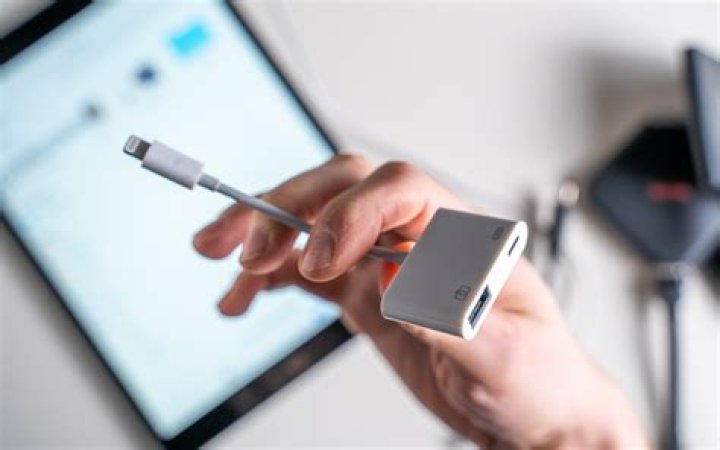 How do you connect an adapter to an iPad?